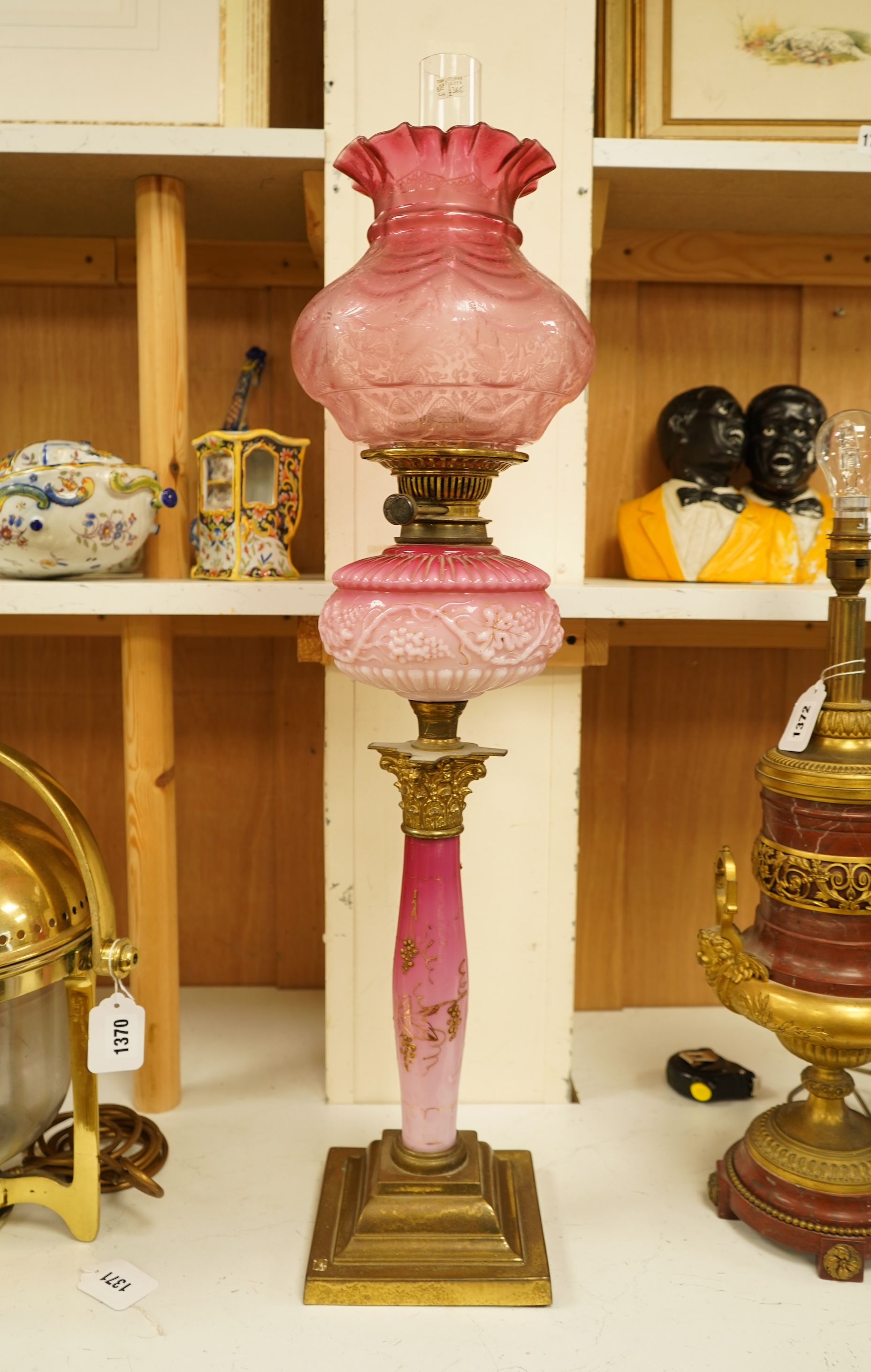 A Victorian brass and ruby glass oil lamp, 80cm high overall